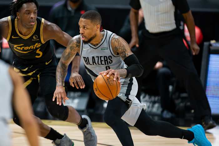 Portland Trail Blazers guard Damian Lillard (0) drives past Toronto Raptors forward OG Anunoby (3) 